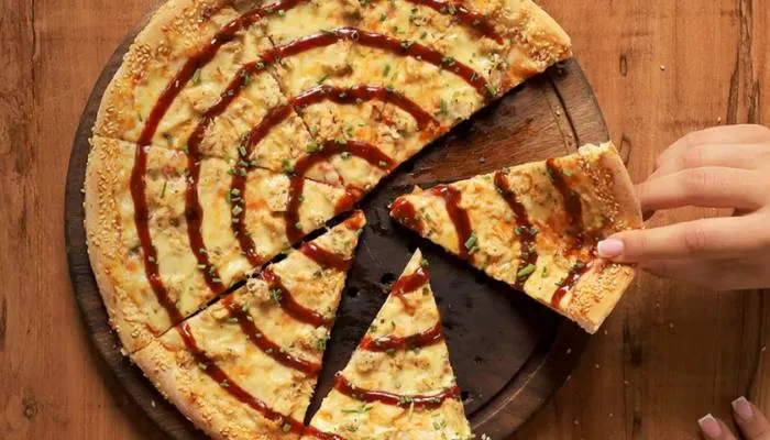 A fresh pizza from Proper Pizza in Albania, featuring their signature sesame-crusted edge.