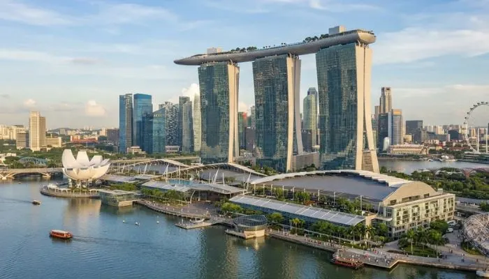 The striking architecture of Marina Bay Sands towers connected by the surfboard-shaped Skypark in Singapore.